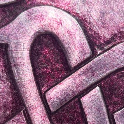 A metallic heart embossed in red wine tones, with a treble clef integrated into the Celtic-styled design.